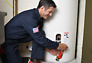 Mark is making a small repair on a conventional water heater